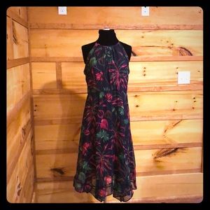 High neck, sleeveless floral dress.